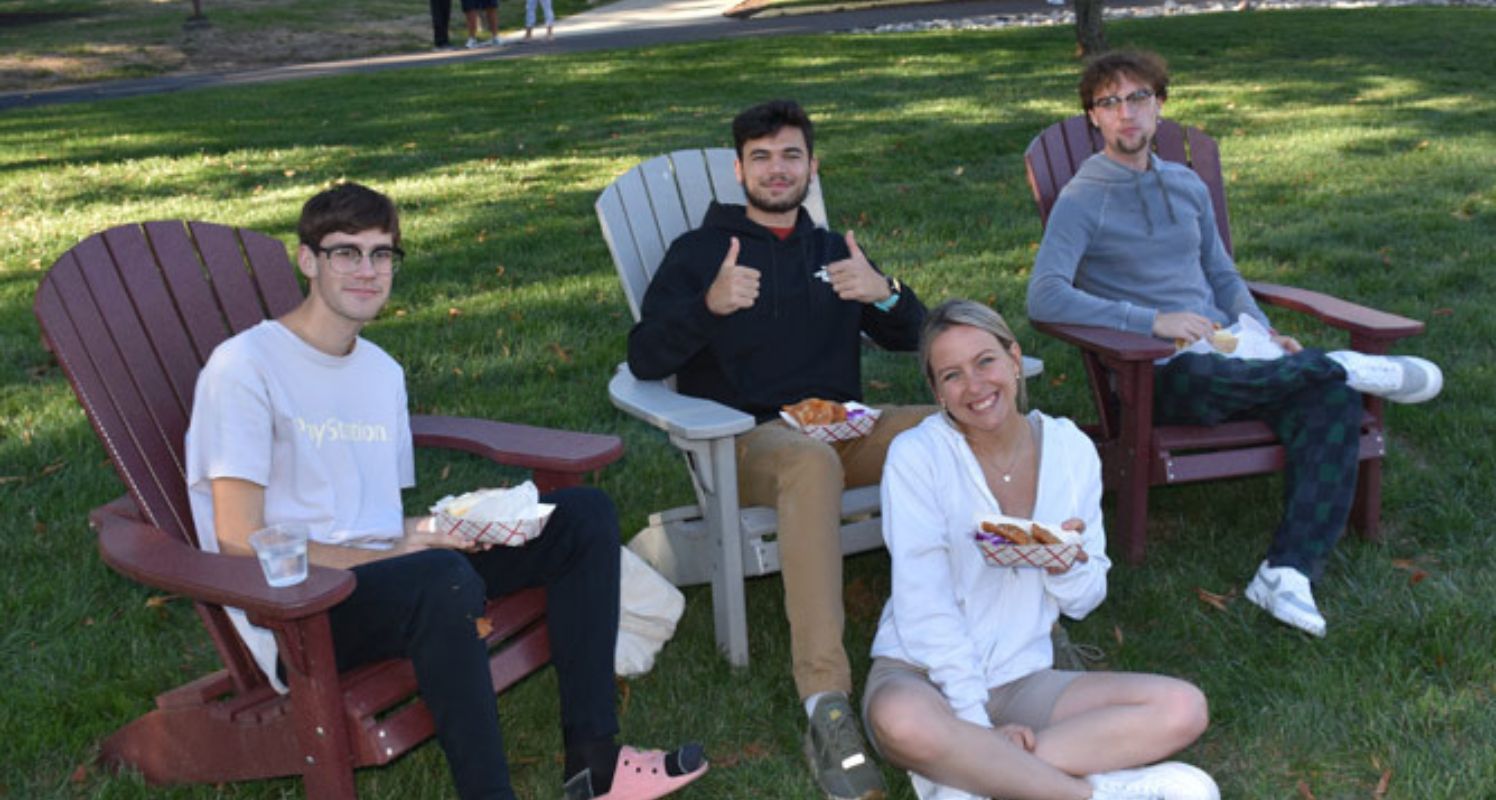 GMercyU students sitting on grass